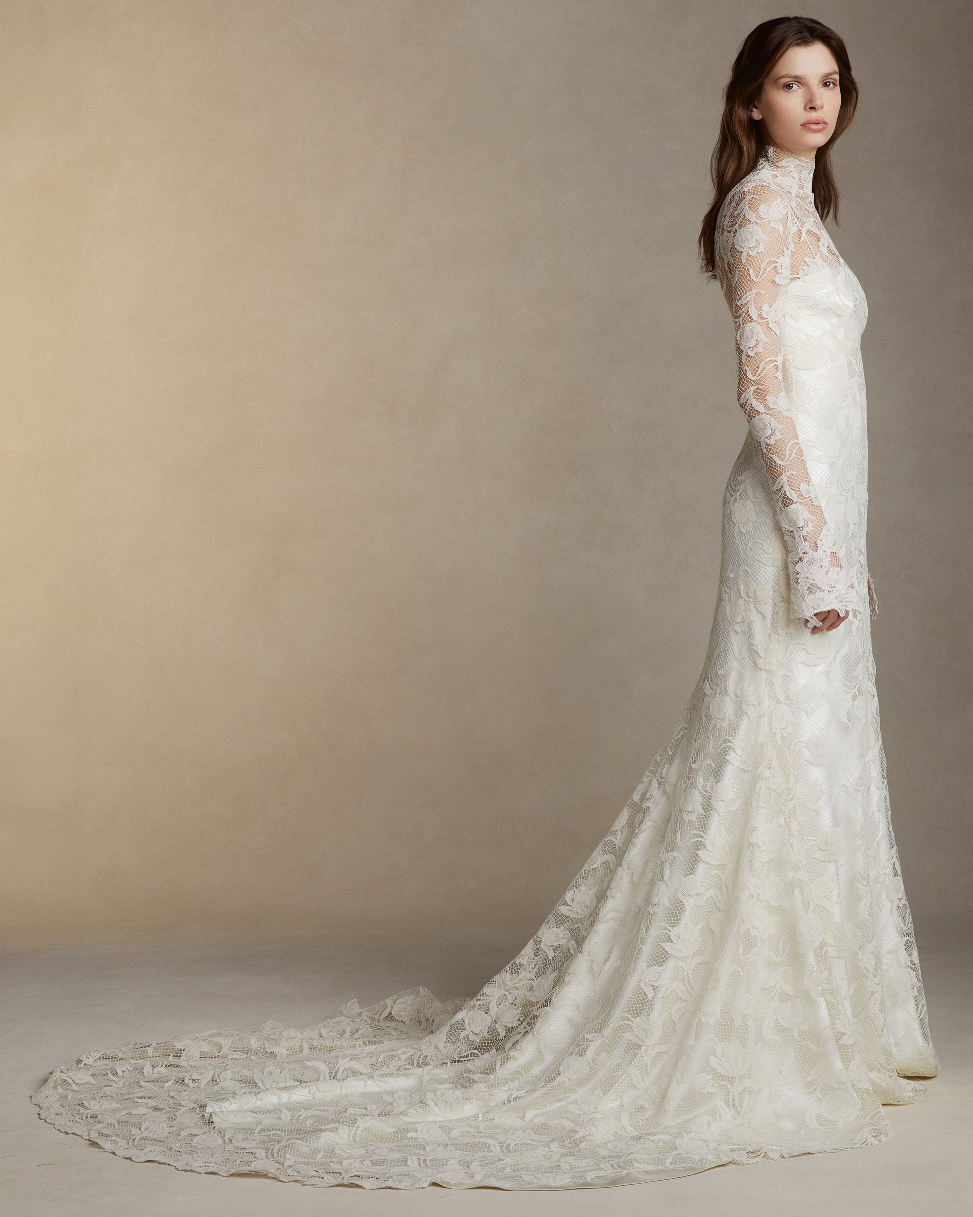 Silk wool long sleeve high neck gown with tulip lace overlay and hand cut Lyon lace appliques. Invisible zip closure at center back.