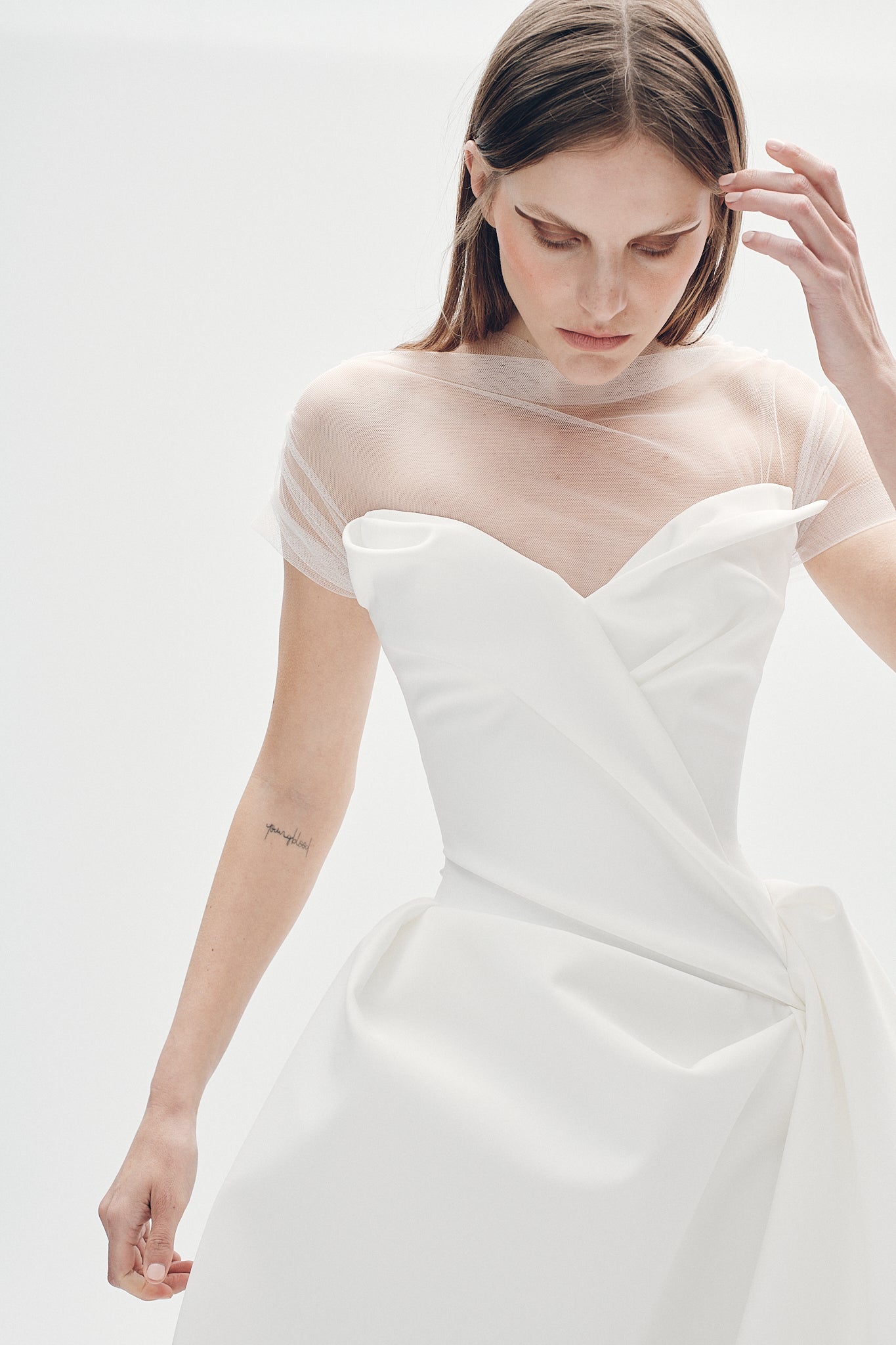 Model wearing the Aliet strapless matte white ballgown with V-sweetheart neckline and asymmetric drape detail