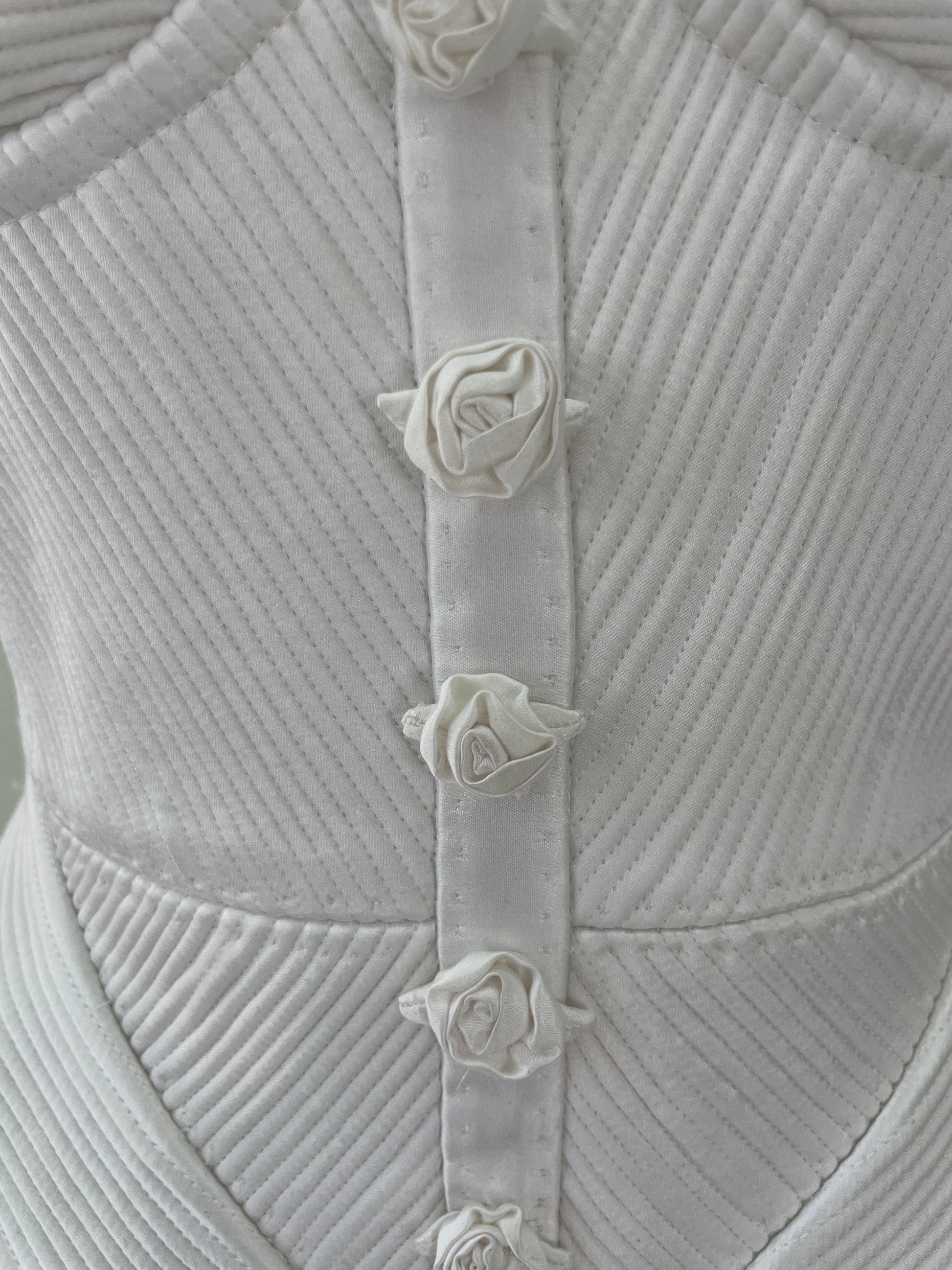 Close-up of a textured fabric surface with floral embellishments.