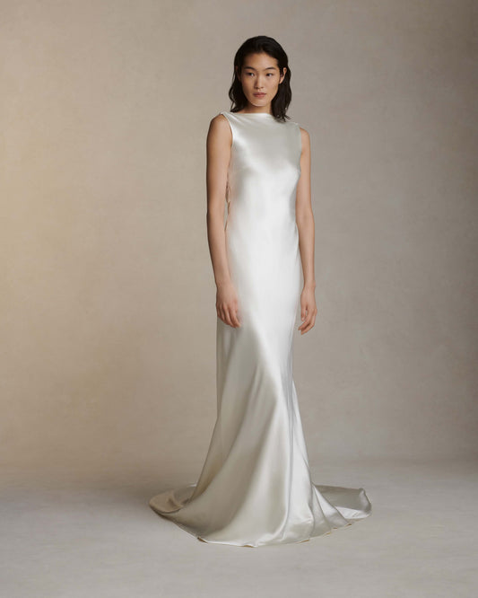 Model wearing the Charlie sleeveless silk wool gown with raised cowl neck and open back in a neutral studio setting