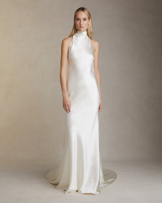 Model wearing the Stella bias cut silk wool high neck halter gown with spaghetti tie closure and baroque pearl detail