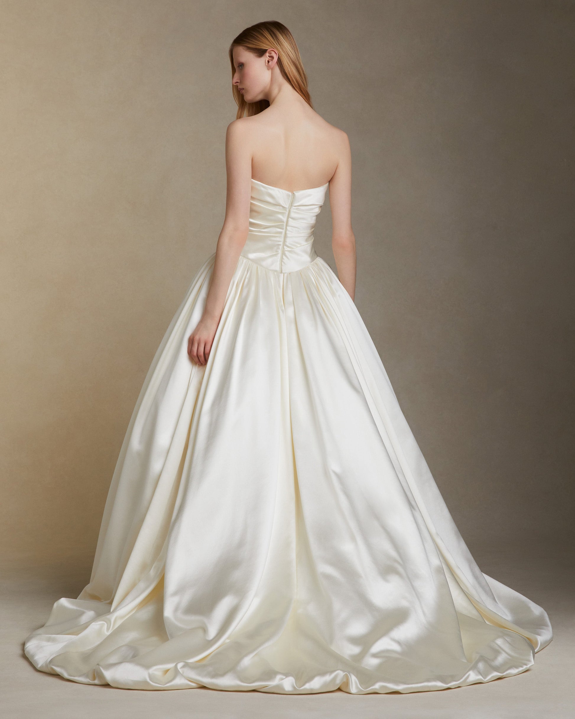 White strapless wedding dress on a plain background