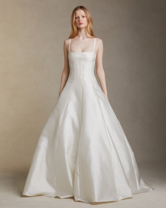Model wearing the Pia silk wool twill gown with square neckline and grosgrain straps against a neutral backdrop